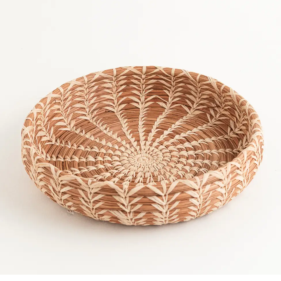 Fair trade small basket made out of pine needles and natural color.