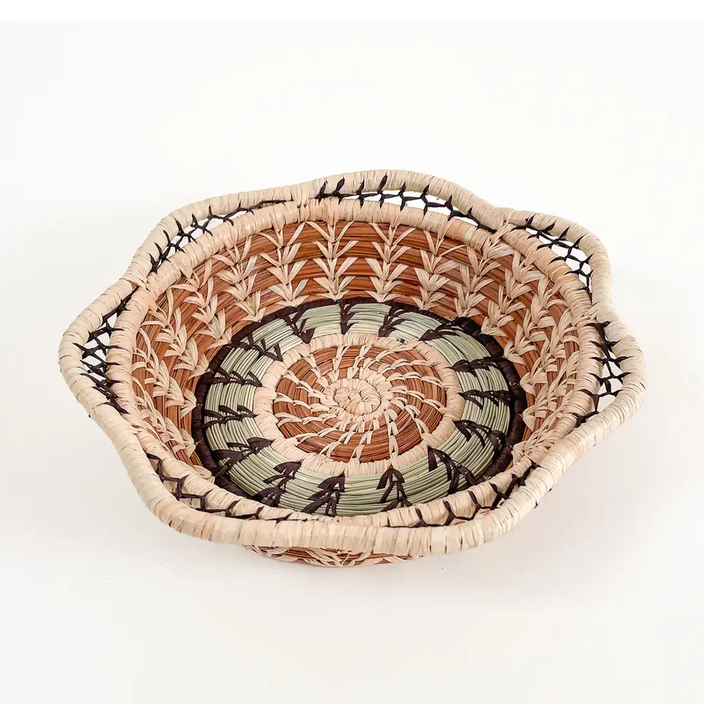 Small pine needle basket round with decorative design, tan and light green.