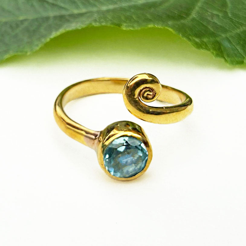 Fair trade adjustable ring with blue topaz stone and brass.