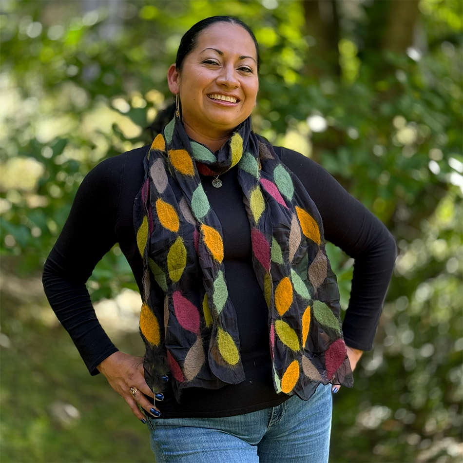Fair trade black silk scarf with felted colorful leaves on top.