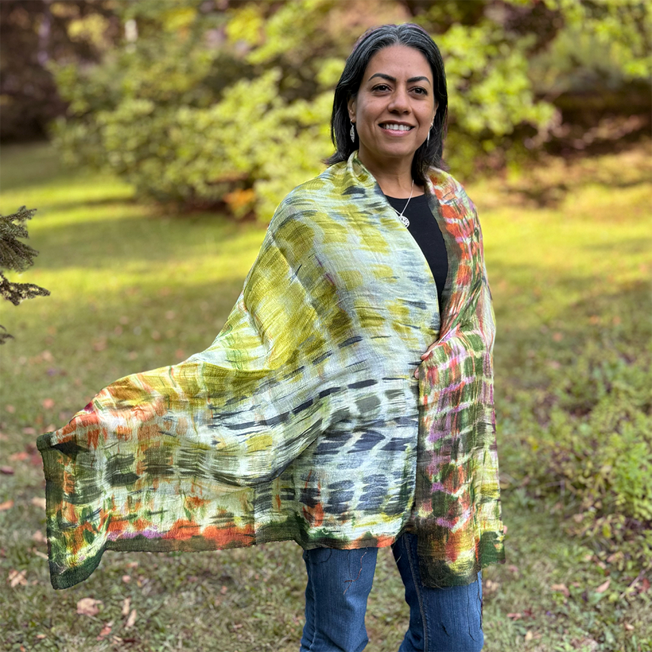 Fair trade silk scarf with a pattern of green, gold, orange and pink.