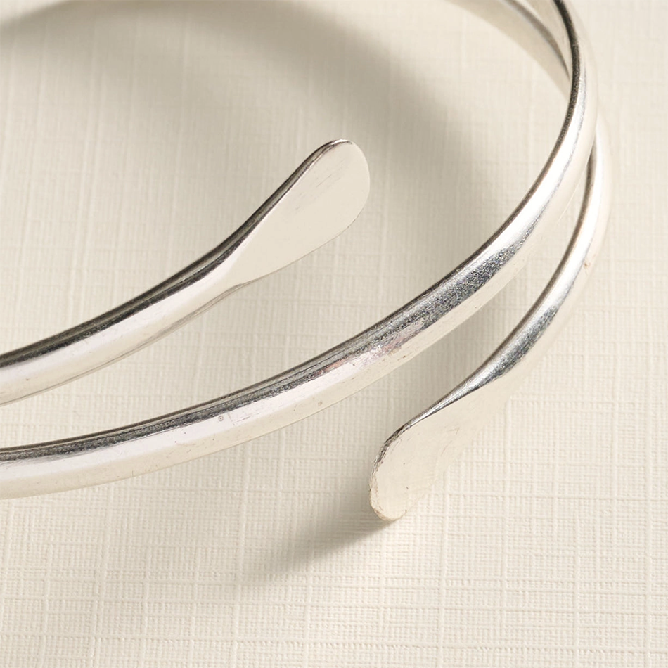 Silver-plated cuff bracelet with 2 spirals meeting in the center