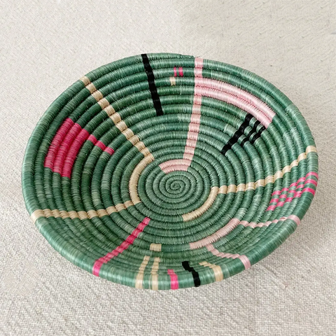 Fair trade sisal bowl basket with sweetgrass, green with pink and black modern design handmade in Rwanda.