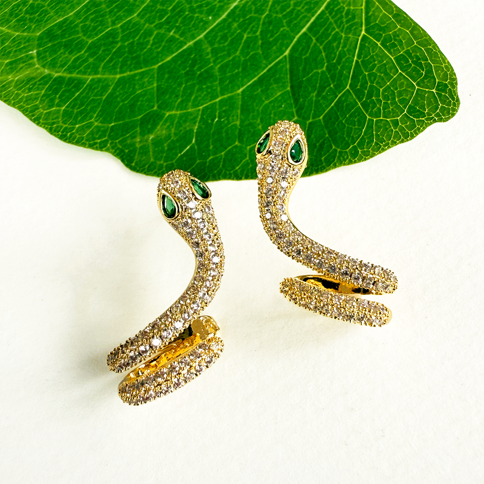 Snake earrings with gold and zircon stones, handmade by survivors of human trafficking.