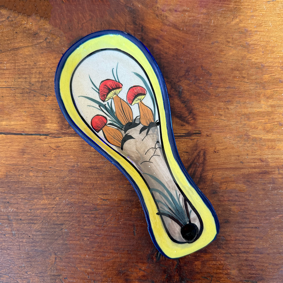 Fair trade ceramic spoon holder with painted mushroom design.