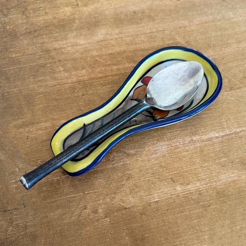 Fair trade ceramic spoon holder with painted mushroom design.