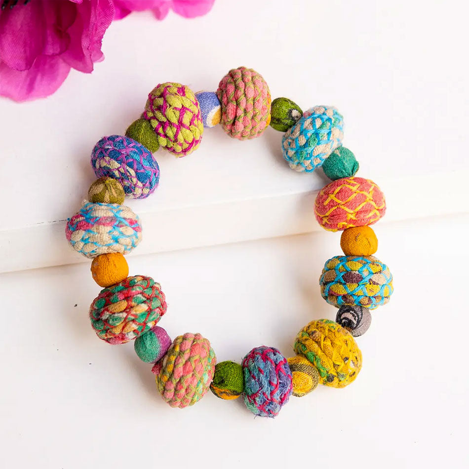 Fair trade statement bracelet handmade out of colorful recycled sari fabric beads.