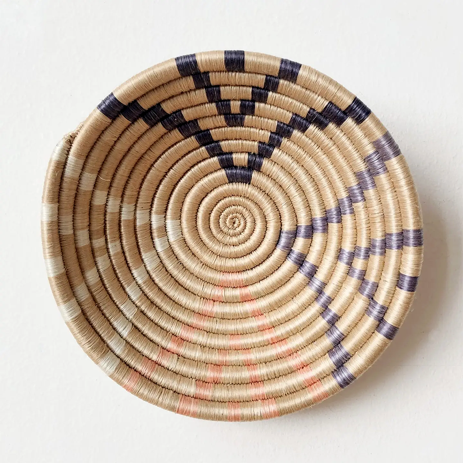 Fair trade sweetgrass basket handmade in Rwanda, natural color with colored accents.