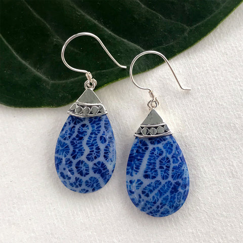 Sterling silver accent earrings with blue coral teardrop design.